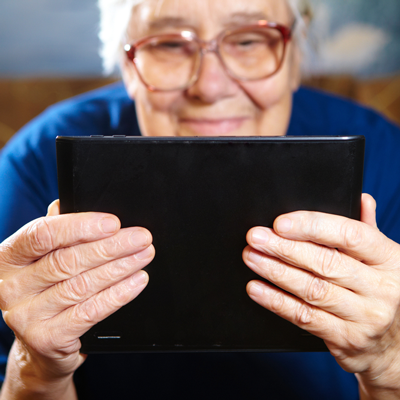 elderly lady looking at tablet